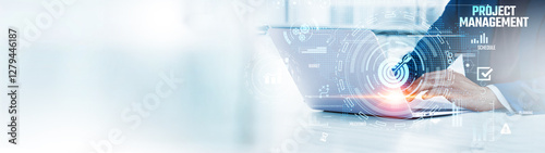 Project Management: Businessman uses laptop to analyze and develop various information about tasks on future virtual interface. Scheduling, resource allocation, team coordination, progress tracking.