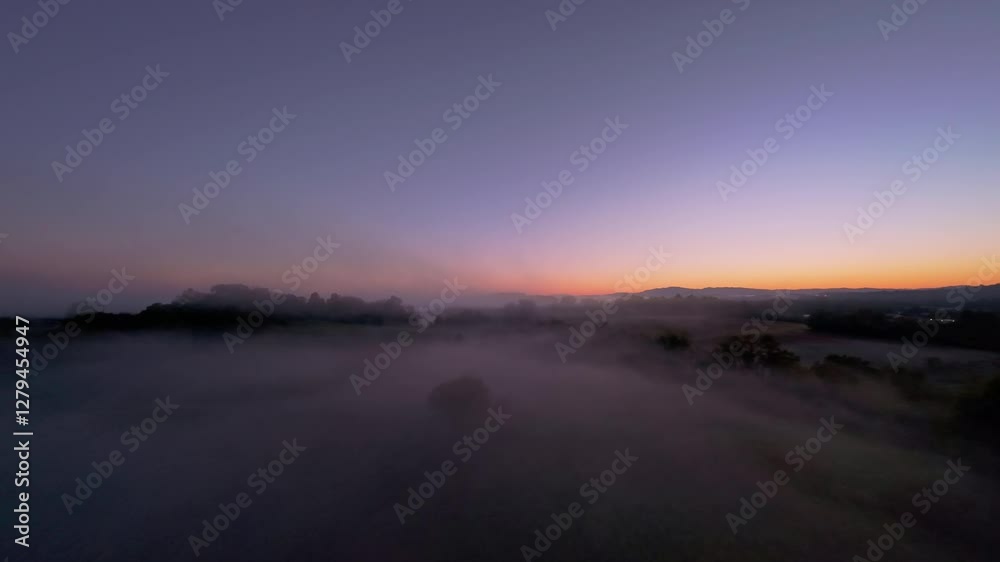 Misty Sunrise Over Johnson City, Tennessee Captured by Drone Drone view of Johnson City, Tennessee, at sunrise, with serene mist blanketing landscape and vibrant sky blending from orange to purple Misty Sunrise Over Johnson City, Tennessee Captured by Drone Drone view of Johnson City, Tennessee, at sunrise, with serene mist blanketing landscape and vibrant sky blending from orange to purple
