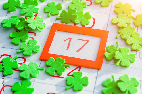 St Patrick's Day background. Green quatrefoils covering the calendar with bright orange framed 17 March - St Patrick's day festive date photo