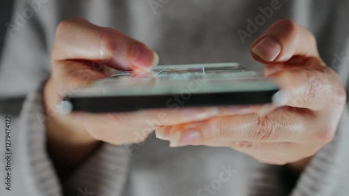 Woman scrolling through social media feeds on smartphone close up