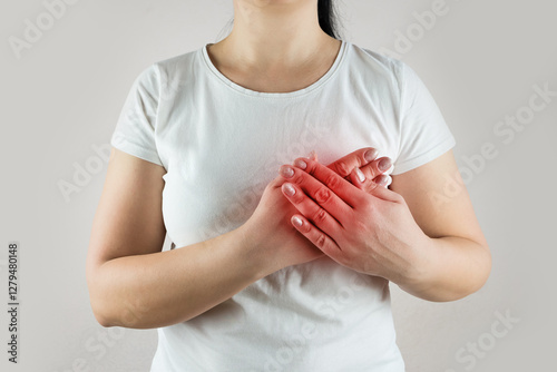 woman in white t-shirt suffers from heart pain. Heart pain.