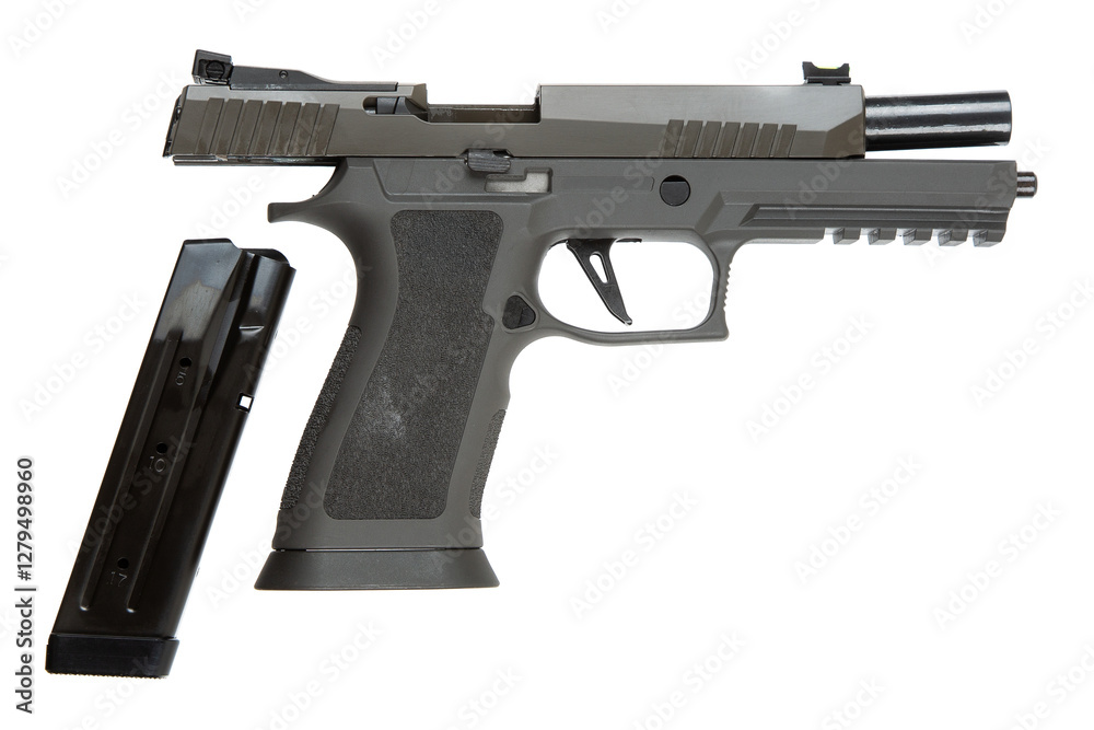 Semi-automatic handgun with a textured grip and an extended magazine, partially open slide revealing the barrel, magazine detached and placed beside, isolated on a white back Semi-automatic handgun with a textured grip and an extended magazine, partially open slide revealing the barrel, magazine detached and placed beside, isolated on a white back