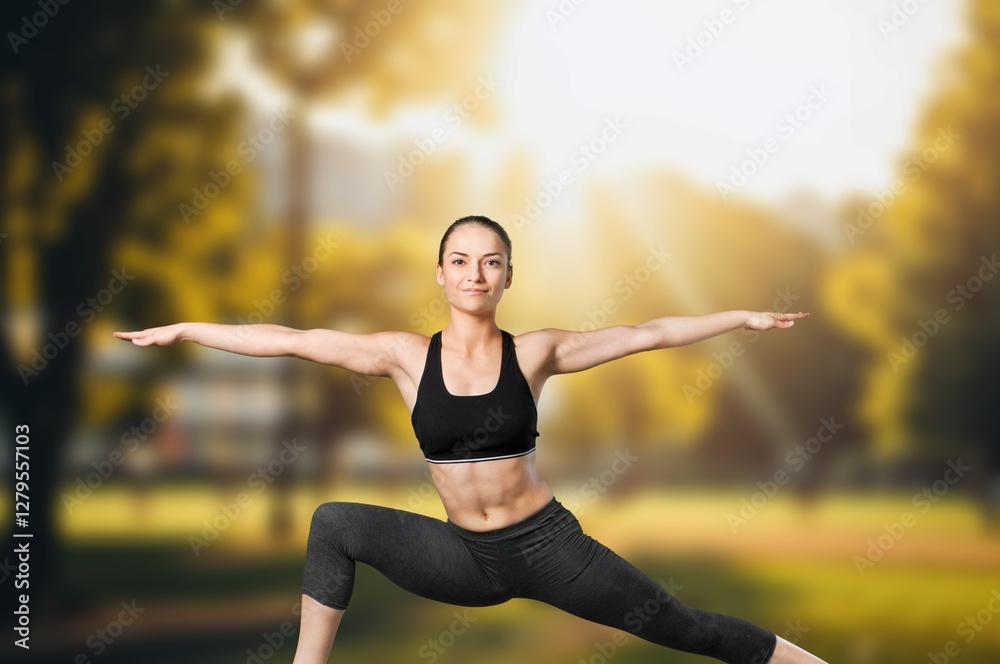 Fototapeta premium Young woman stretching body, doing yoga.