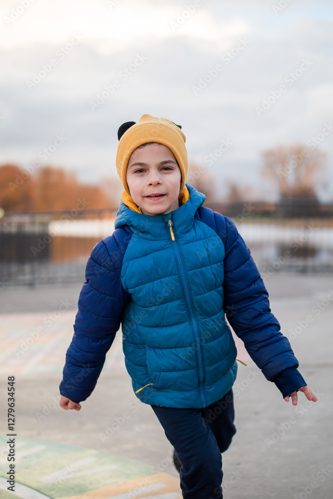 Portrait of little adorable boy walking in park