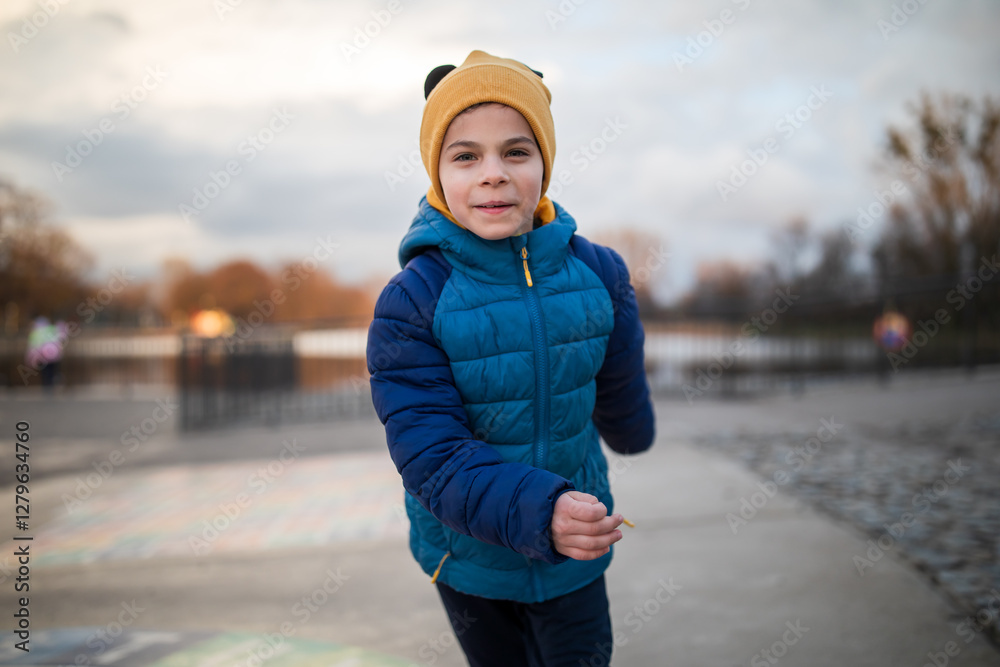 Portrait of little adorable boy walking in park