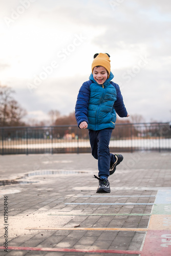 Obraz na płótnie Portrait of little adorable boy walking in park w salonie