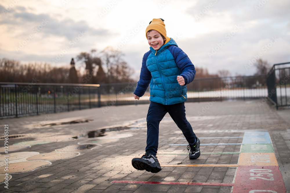 Portrait of little adorable boy walking in park
