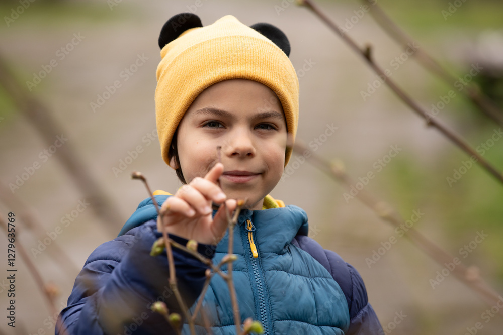 Portrait of little adorable boy walking in park