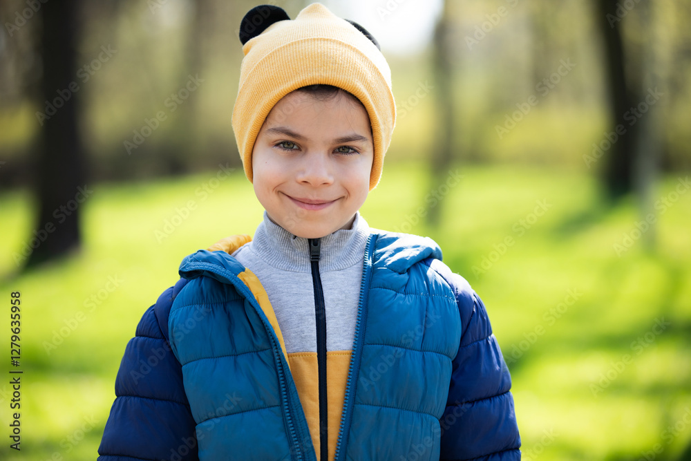 Portrait of little adorable boy walking in park