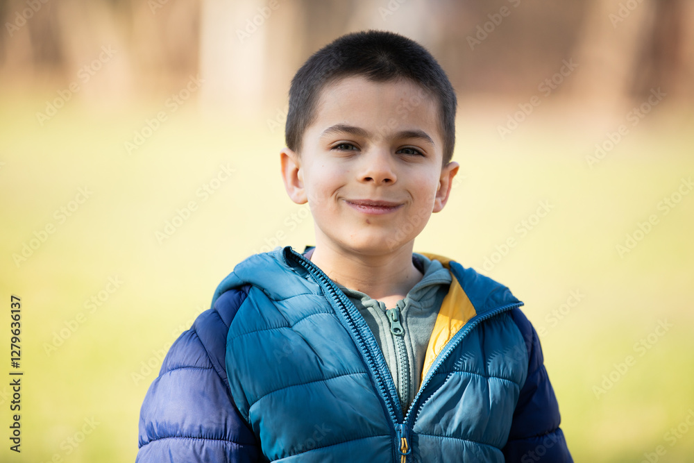 Portrait of little adorable boy walking in park