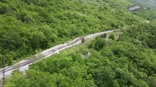 Aerial drone view of Pijana pruga or drunk railway in Istria, Croatia. A stretch of neglected railway track and bed, deformed rails, washed down by land slide or poor earth base photo