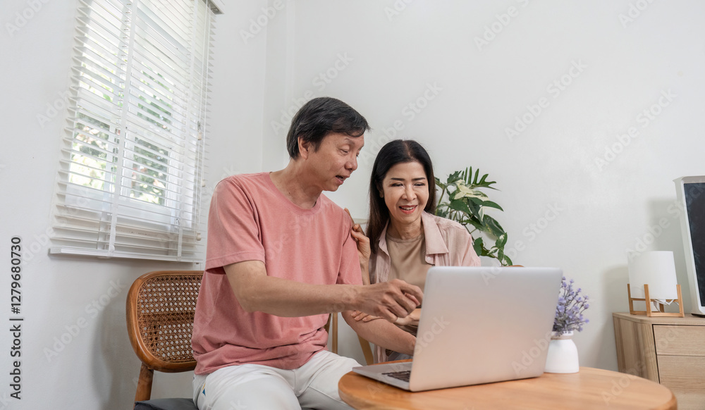 Senior couple excitedly exploring content on a laptop at home. Senior couple excitedly exploring content on a laptop at home.
