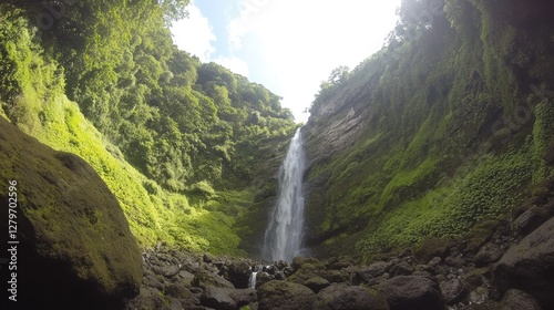 A majestic waterfall cascading down moss-covered rocks in a lush green forest, bright sunlight filtering through trees, ample copy space.
