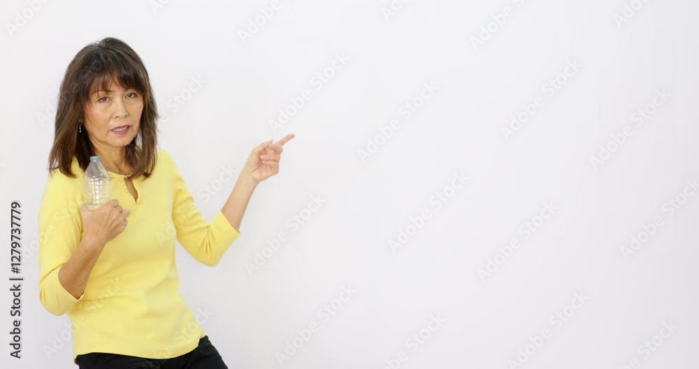 Woman model holding water bottle pointing at copy space text placeholder Woman model holding water bottle pointing at copy space text placeholder