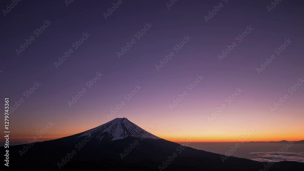 Aerial video captures a serene mountain at twilight, showcasing a tranquil landscape with a vast sky, creating a peaceful, cinematic atmosphere. Aerial video captures a serene mountain at twilight, showcasing a tranquil landscape with a vast sky, creating a peaceful, cinematic atmosphere.