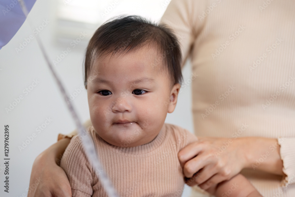 Pediatric doctor interacting with baby during a check up while parent supports child. Pediatric doctor interacting with baby during a check up while parent supports child.
