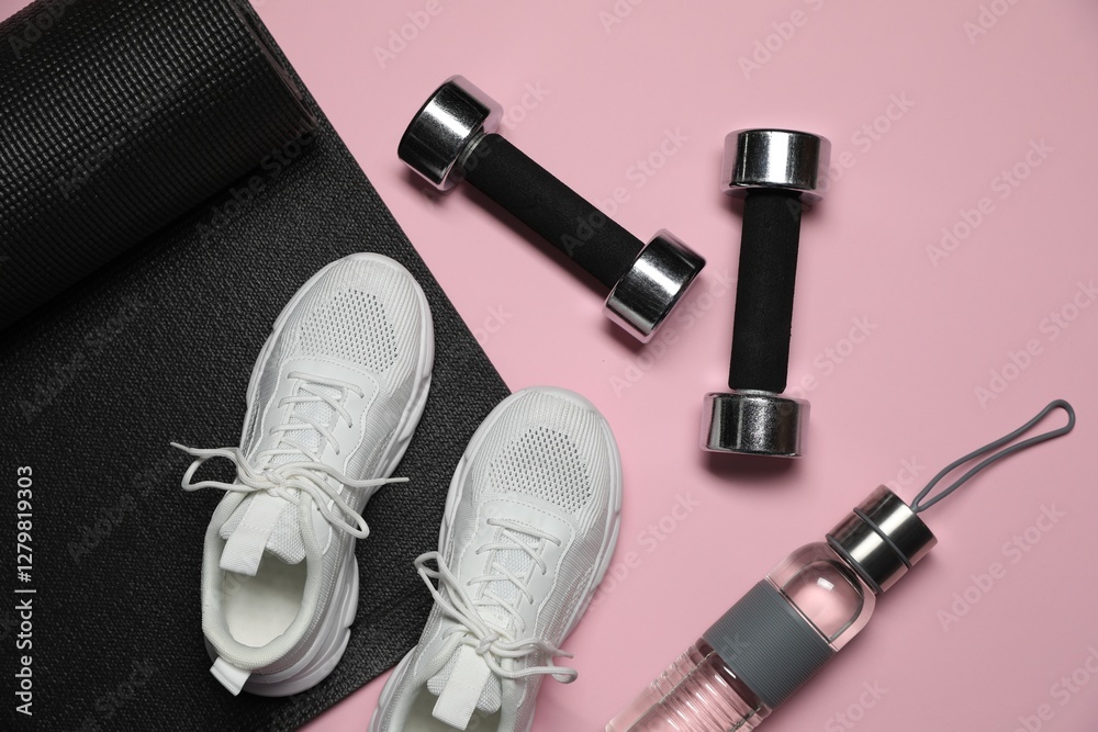Fototapeta premium Dumbbells, water bottle, fitness mat and sneakers on pink background, flat lay