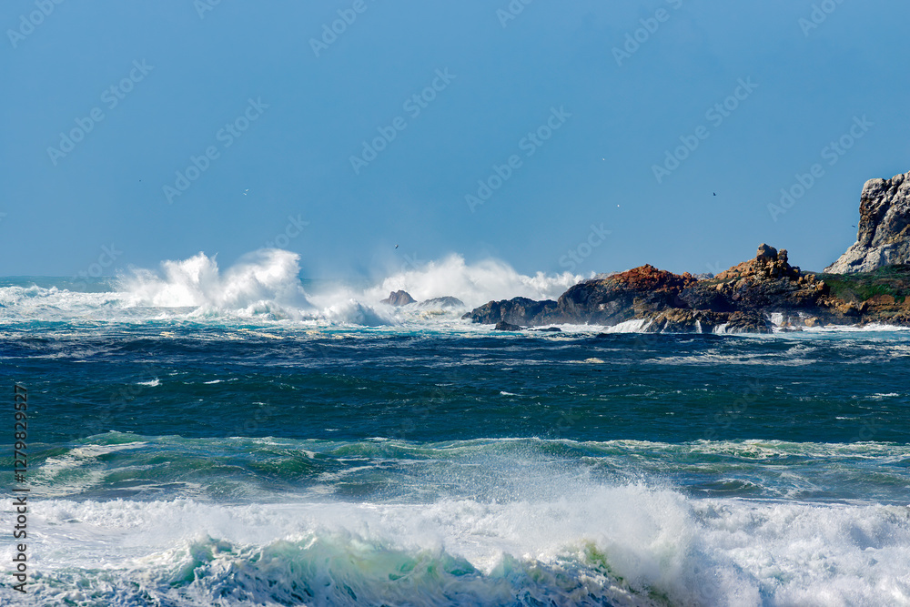 Fototapeta premium Spectacular splashes as wind driven waves strike Piedras Blancas Lightstation.