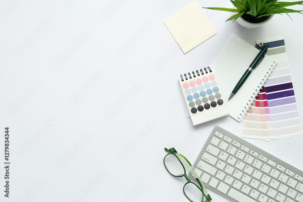 Composition with eyeglasses, keyboard and notepad on light background Composition with eyeglasses, keyboard and notepad on light background