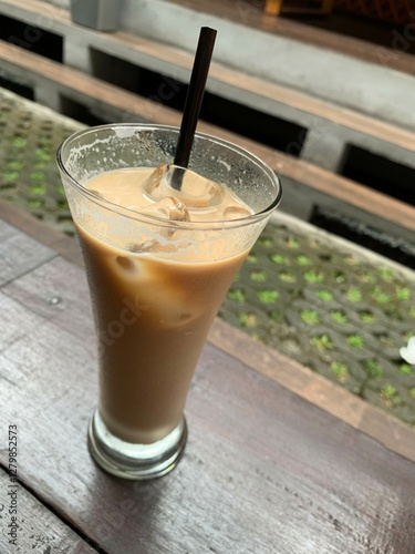 a glass of Spanish latte cortado with ice and a nice cold coffee taste in minimal style cafe, Cool summer drink. photo