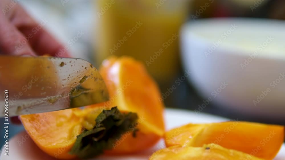 Cutting into pieces of ripe orange persimmon, cooking food using fresh persimmon, which is cut into pieces. High quality 4k footage Cutting into pieces of ripe orange persimmon, cooking food using fresh persimmon, which is cut into pieces. High quality 4k footage