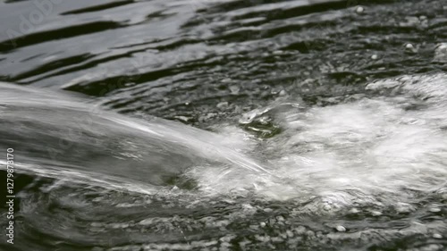 a fountain flowing in still water