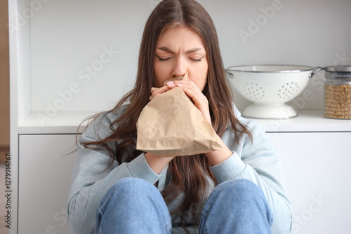Young woman with paper bag ...
