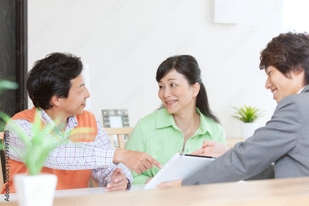 営業マンと打ち合わせをする夫婦 営業マンと打ち合わせをする夫婦