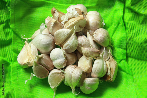 garlic abstract layout on green background, garlics  clove studio shot