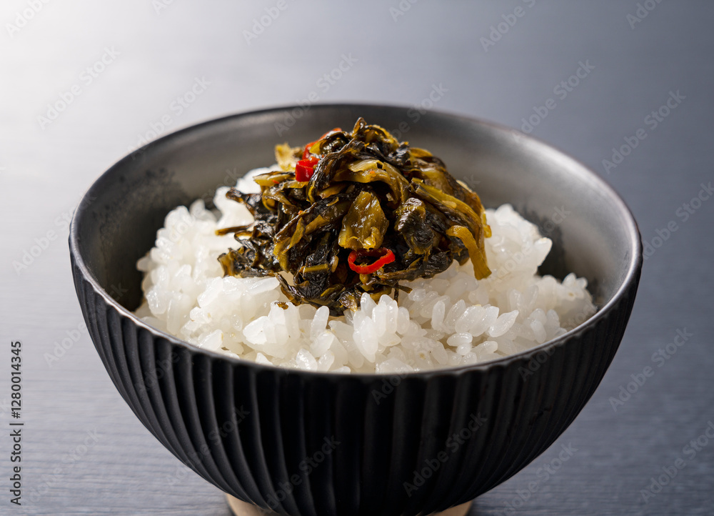 Karashi Takana on Rice on a Black Background – Karashi Takana: A Japanese-Style Pickle Made from Mustard Greens Karashi Takana on Rice on a Black Background – Karashi Takana: A Japanese-Style Pickle Made from Mustard Greens
