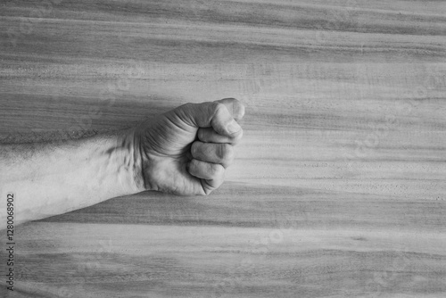 fist punching through paper photo