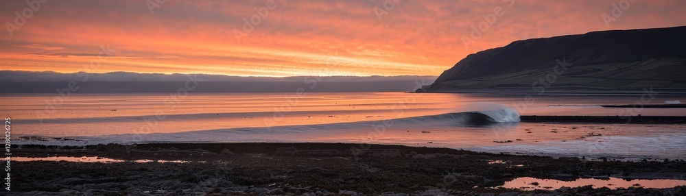 A serene coastal sunset scene with gentle waves lapping against the shore, illuminated by vibrant colors in the sky. A serene coastal sunset scene with gentle waves lapping against the shore, illuminated by vibrant colors in the sky.