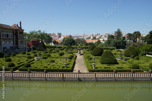 Palace Fronteira in Portugal. Formal gardens with manicured hedges and topiaries. A grand palace in the background. Portugal, a symbol of wealth and power. A reminder of Portugal's rich history.