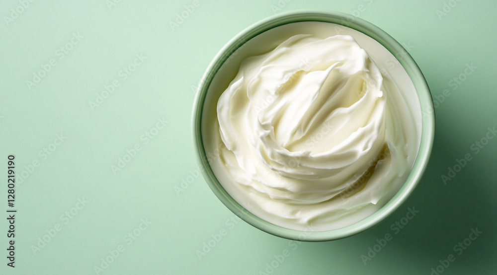 A top-down view of white cream in an all-green background, A top-down view of white cream in an all-green background,
