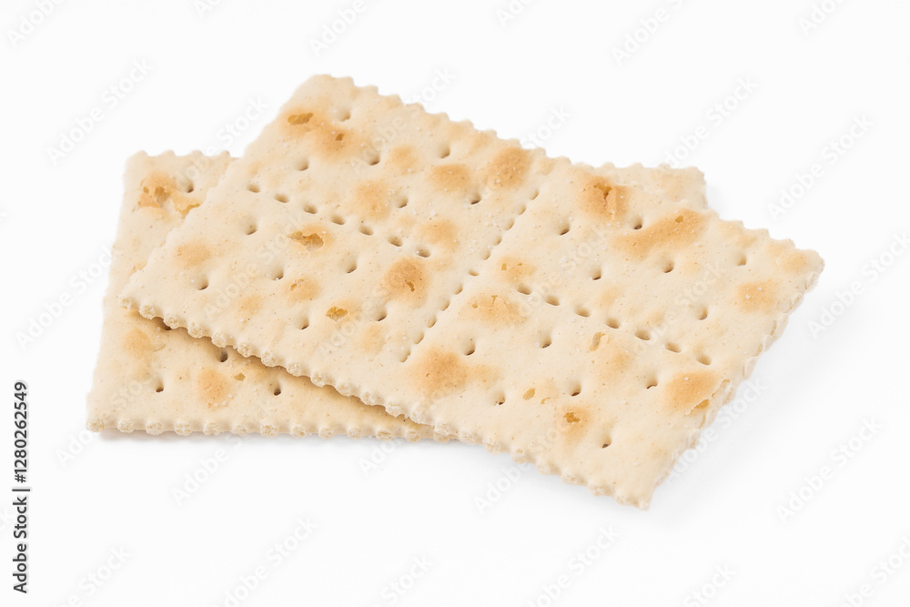 Close-up of crispy saltine crackers isolated on a white background. Simple and classic snack, perfect for food photography, culinary projects, and product presentations. Close-up of crispy saltine crackers isolated on a white background. Simple and classic snack, perfect for food photography, culinary projects, and product presentations.