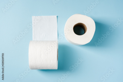 Top view of toilet paper roll on blue background