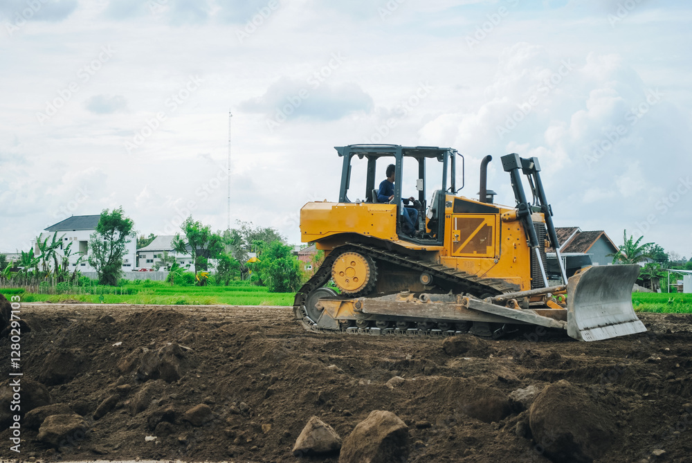 Fototapeta premium A large bulldozer is doing excavation work at a construction site.