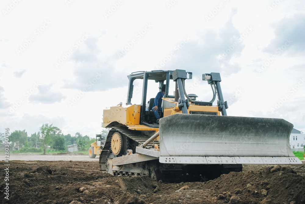 A large bulldozer is doing excavation work at a construction site. A large bulldozer is doing excavation work at a construction site.