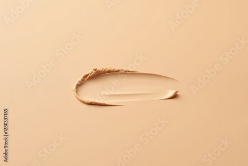 A Smear of Light Beige Foundation on a Neutral Background