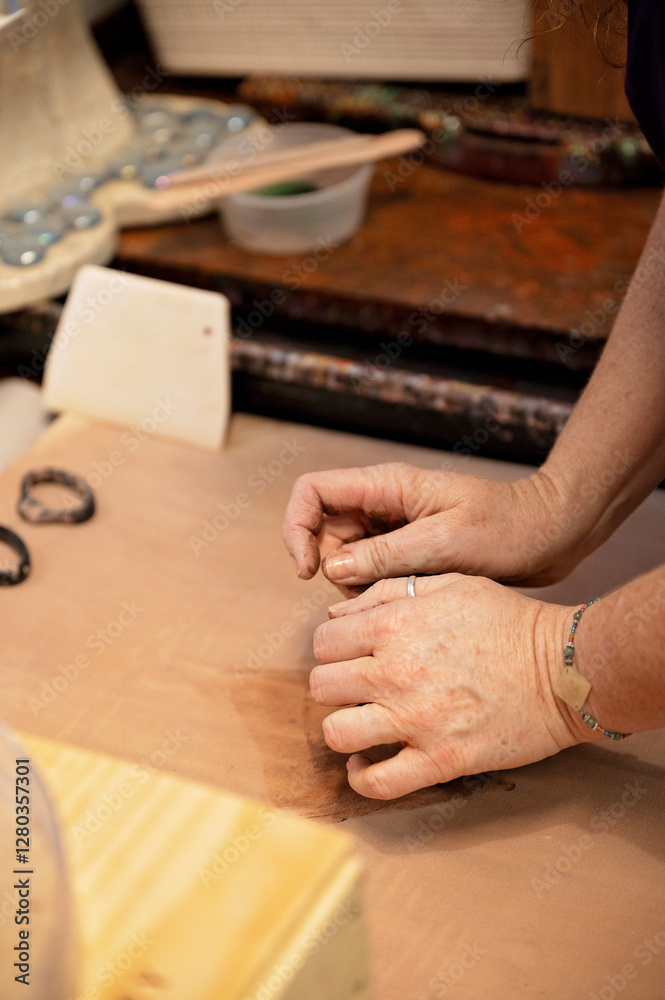 Artisan's hands shaping clay in a pottery studio workspace Artisan's hands shaping clay in a pottery studio workspace