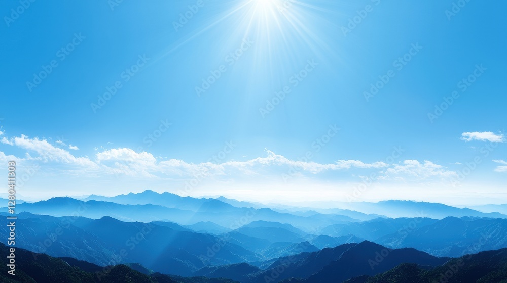 Obraz premium Panoramic view of a mountain range under a bright sun with clear blue sky and lush green valleys