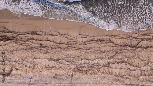Static Aerial View of Ocean Waves Meeting Sandy Beach