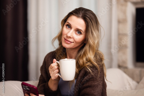 Wallpaper Mural Portrait of a pretty young woman with a cup of coffee in her hands on a gray background. Torontodigital.ca