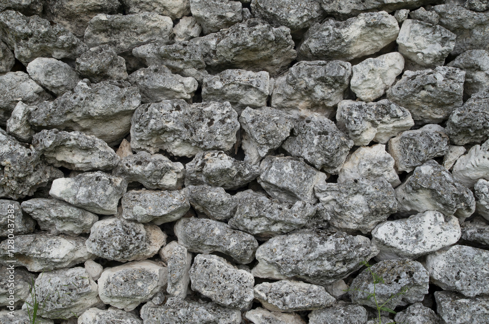 Old stone wall of unjoined rough white limestones closeup Old stone wall of unjoined rough white limestones closeup