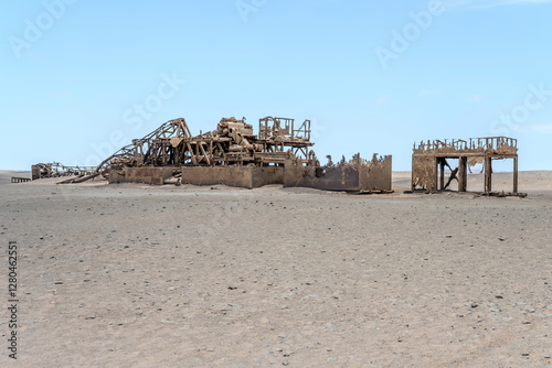 Obraz na płótnie remains of run-down Drill Rig on desert sand, Old oil Rig site, Skeleton coast, Namibia w salonie