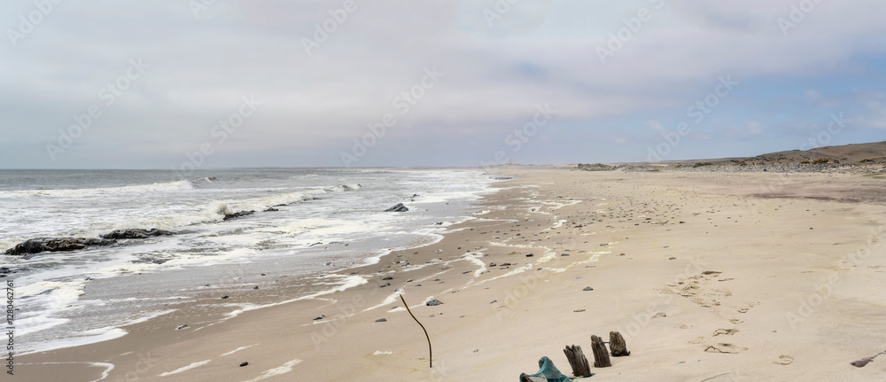 wave froth on large beach at Ocean shore, near South West Seal shipwreck, Skeleton coast, Namibia