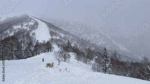 Snowy Slopes of Tomamu, Hokkaido – Skiers and Snowboarders Enjoying Winter photo