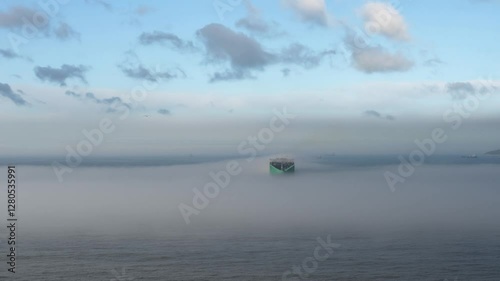 giant container ship sailing in the mist