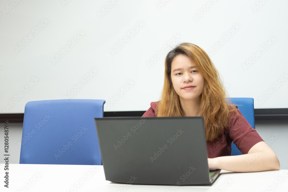 Woman working by laptop in office with happy Woman working by laptop in office with happy