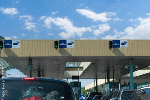 Customs checkpoint for cars. Passport verification and document inspection at border crossing. European border crossing sign with green traffic light.